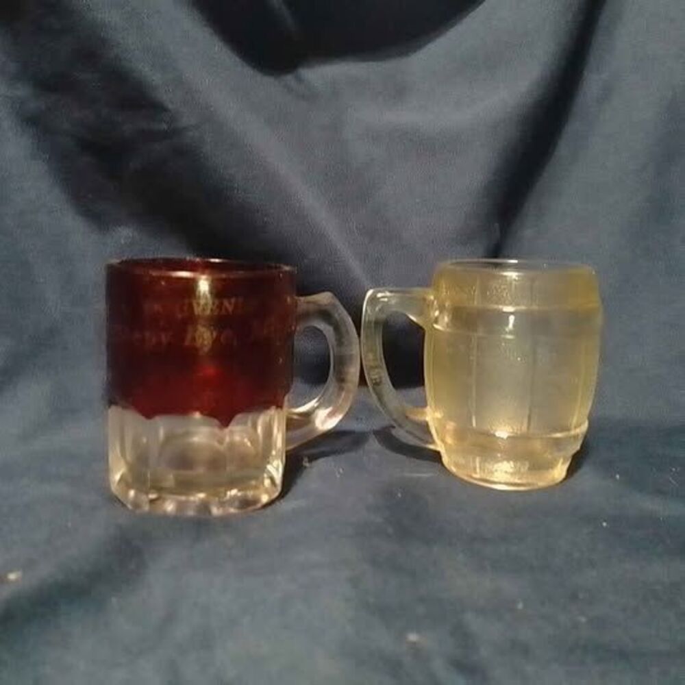 two vintage miniature glass mugs function as souvenir shot glass